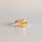 Load image into Gallery viewer, Gold leaf-shaped ring on a light gray background
