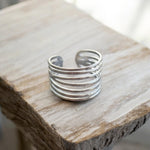 Load image into Gallery viewer, Silver ring with multiple bands on a wooden surface
