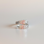 Load image into Gallery viewer, Silver feather-shaped ring on a light gray background
