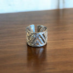 Load image into Gallery viewer, Silver ring with geometric design on a wooden surface
