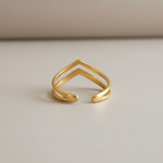Load image into Gallery viewer, Gold open ring with geometric design on a beige background
