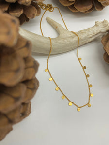 Waterproof minimalistic layering necklace with little circles available in gold and silver.